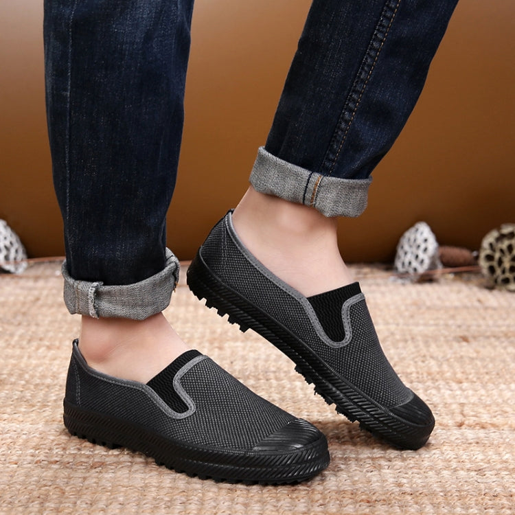 Men's slip-on work shoes worn with jeans, textured upper and traction rubber sole