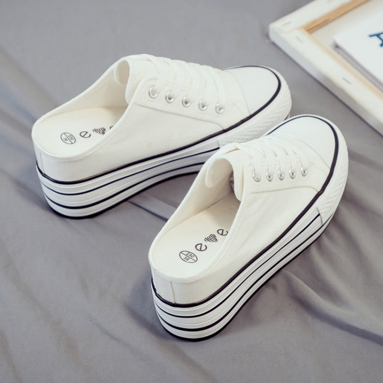 White canvas platform slip-on sneakers with lace-up front and thick stacked sole