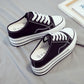 Women's thick-soled canvas platform slip-ons, pair view with dark canvas and white laces