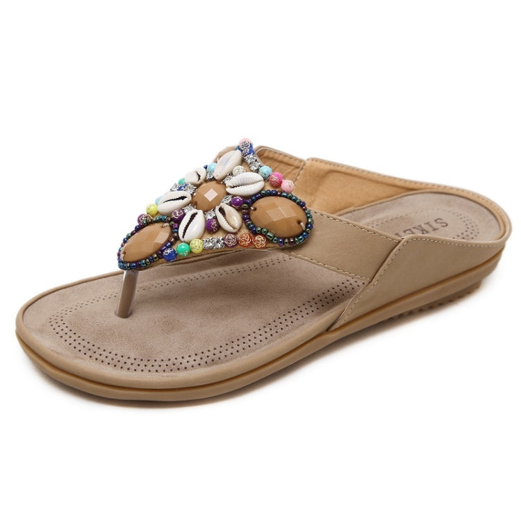 Tan bohemian beaded thong sandals with shell decorations and perforated footbed