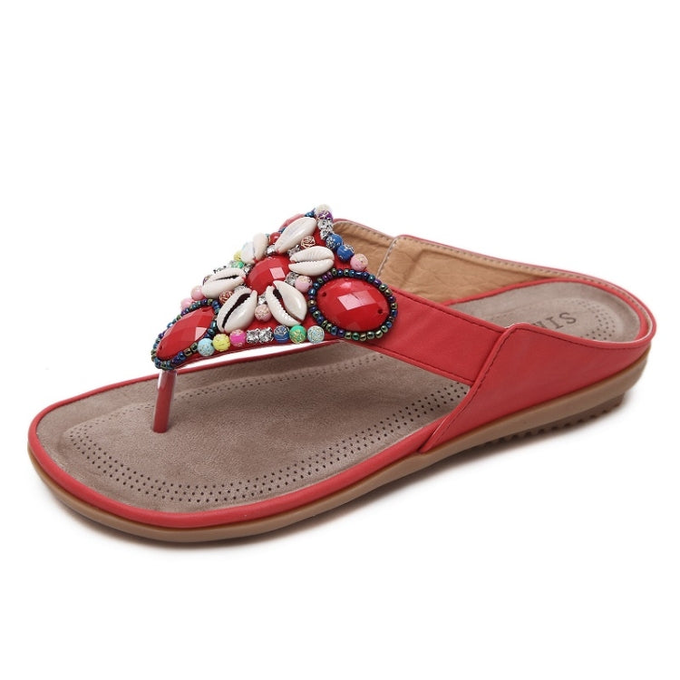 Red beaded thong sandals with multicolor shell details and textured footbed