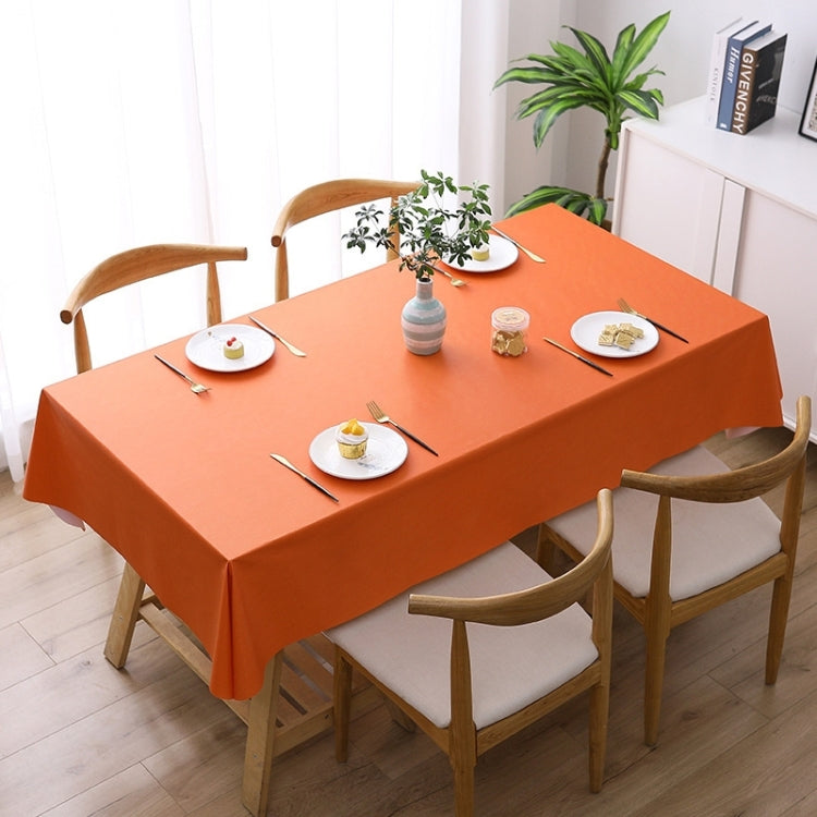 Orange waterproof disposable tablecloth covering a dining table