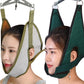 Cervical traction sling with light green straps and gray hood, side view on person
