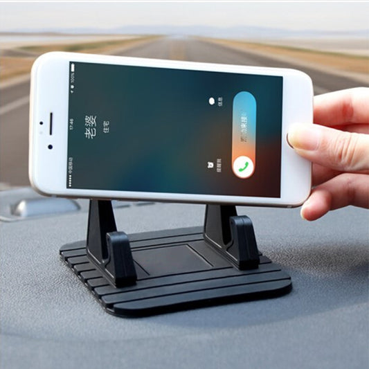 Black mini car phone stand holding a smartphone horizontally on the dashboard
