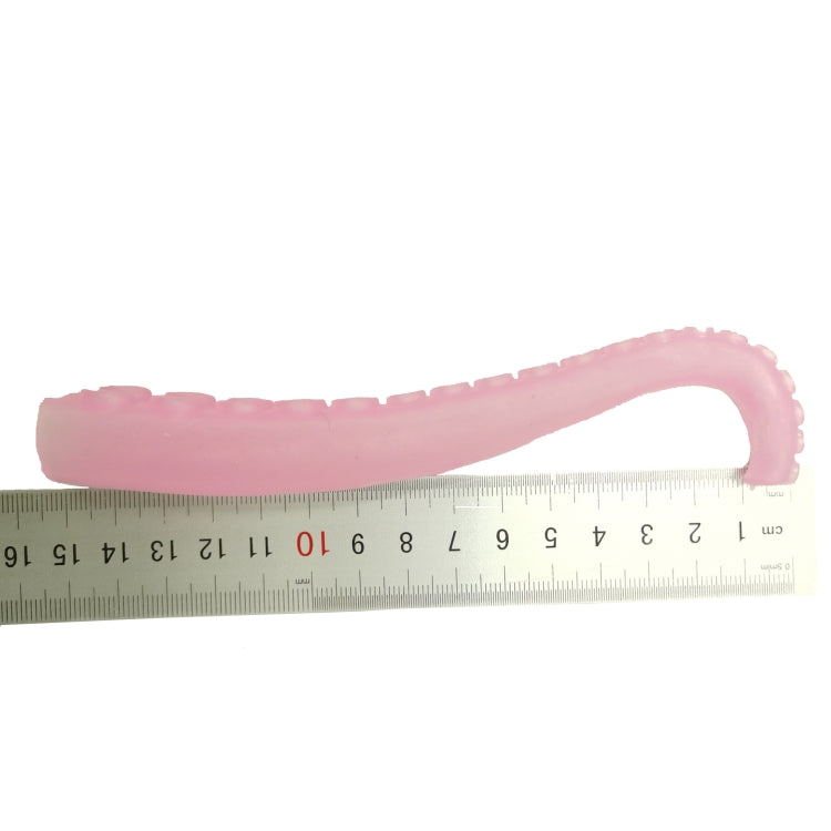 Pink octopus tentacle finger cover on a measuring tape, soft plastic length