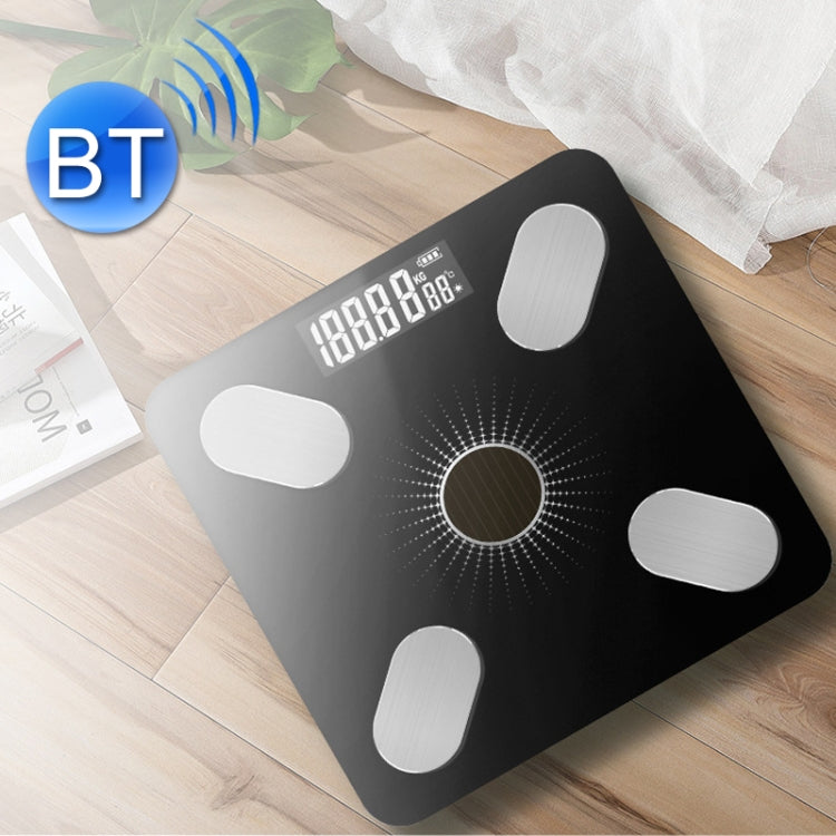 Black smart Bluetooth weight scale on wood floor with bright digital screen