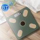 Green smart Bluetooth weight scale on wood floor with bright digital screen