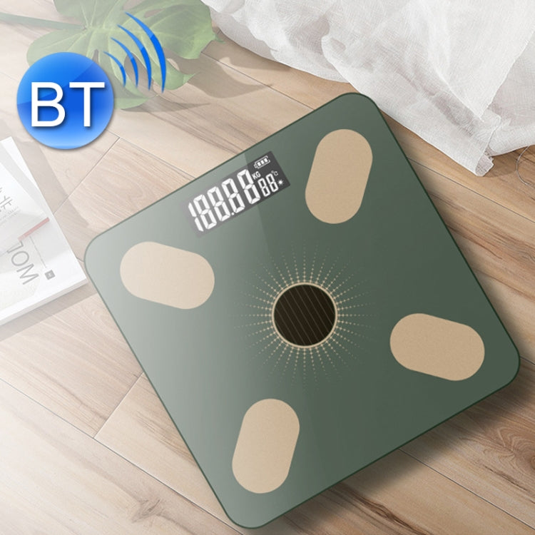 Green smart Bluetooth weight scale on wood floor with bright digital screen