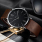Men’s quartz wristwatch with black dial, silver case, and brown leather strap