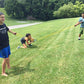 Elastic water balloon launcher setup with yellow cords stretched between players.