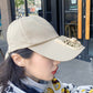 Beige fan sun cap worn by model with built-in vent housing and curved brim