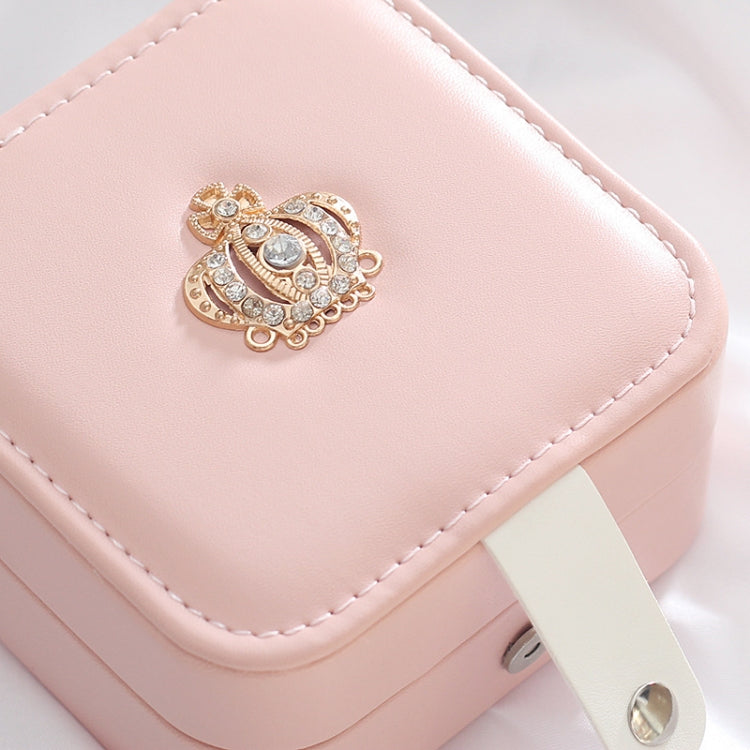 Pink leather jewelry box lid with gold decorative clasp and stitched edges