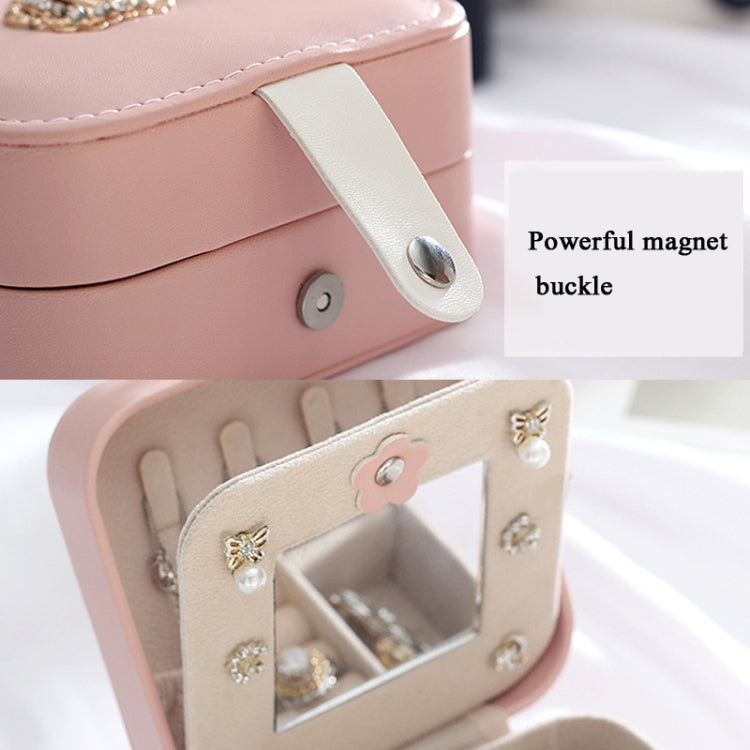 Pink leather jewelry box with magnetic clasp detail and open earring organizer
