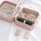 Pink portable jewelry box open with ring and earring organizer compartments