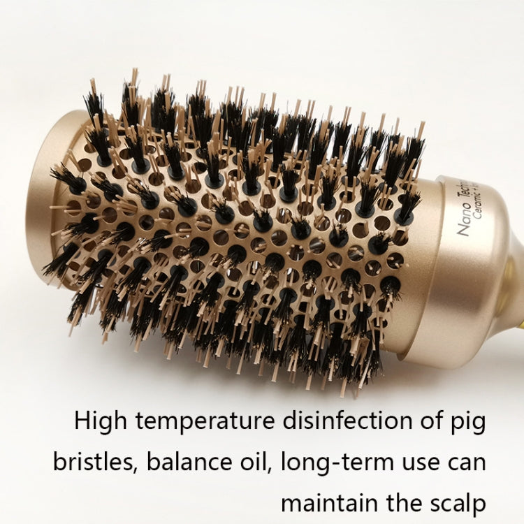 Close-up ceramic roller brush with gold barrel and black bristles, textured handle