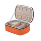 Orange travel jewelry storage box with open lid and padded ring organizer insert