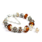 Orange crystal and glass bead bracelet with silver-tone crown charm and amber faceted beads