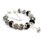 Black crystal bead bracelet with filigree silver-tone bead caps and charm details