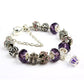 Crystal beaded bracelet with purple faceted beads and decorative silver-tone end caps