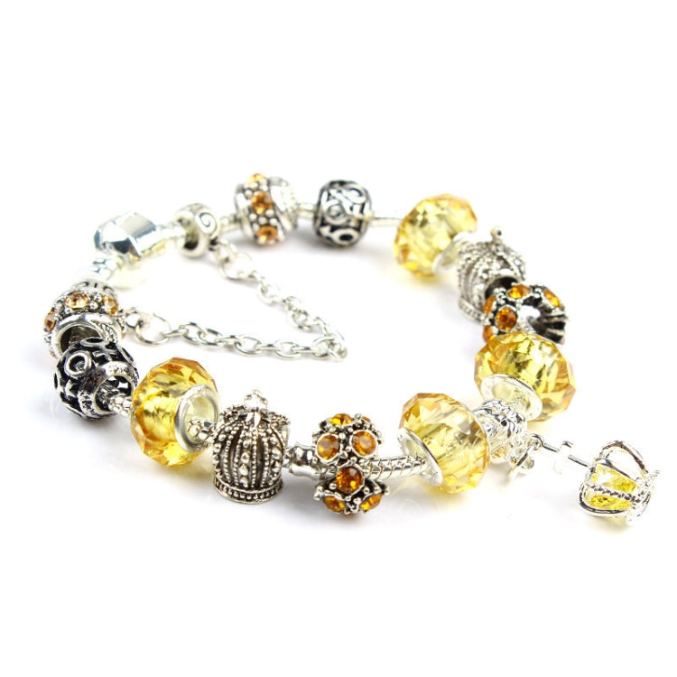 Crystal beaded charm bracelet with golden-yellow beads, mixed filigree beads, and round end caps
