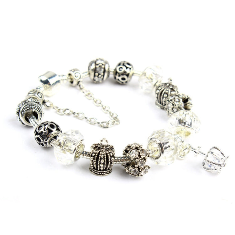 Silver-tone beaded bracelet with decorative charms and clear crystal beads, lobster clasp end