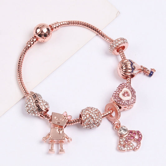 Rose gold beaded charm bracelet with rhinestone charms, heart, and figure dangles