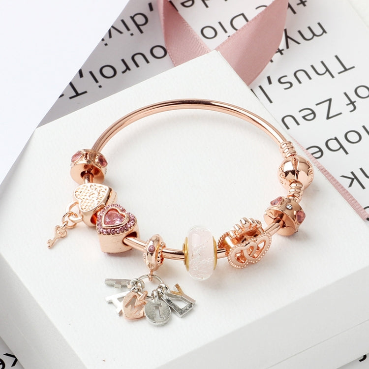 Rose gold charm bracelet with heart lock bead, heart and key-shaped dangles