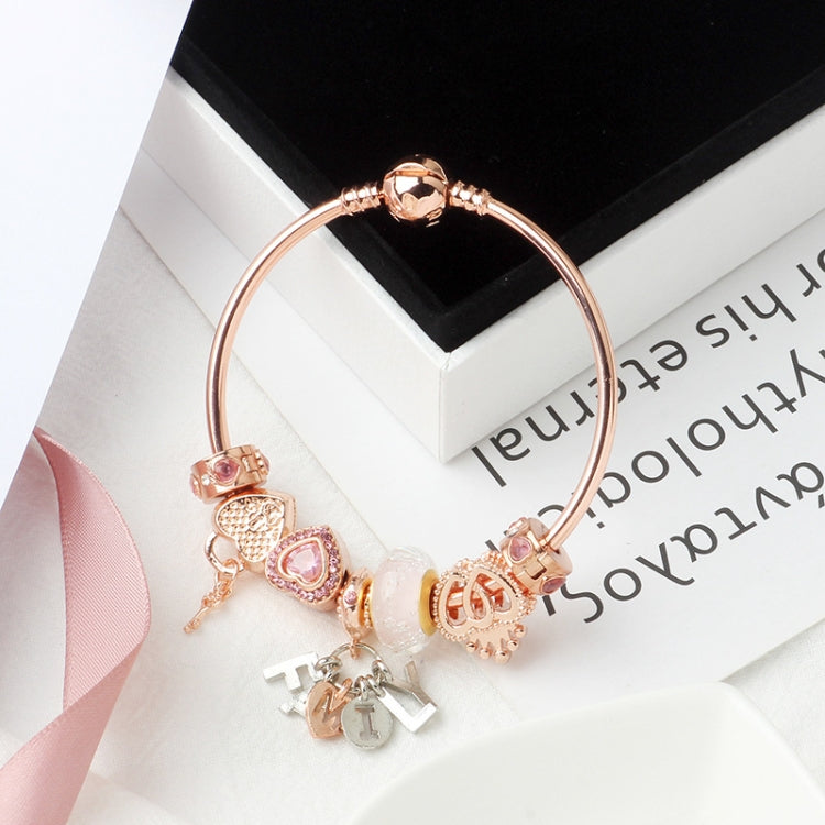 Rose gold heart lock charm bracelet with pink heart charms and letter dangle tags