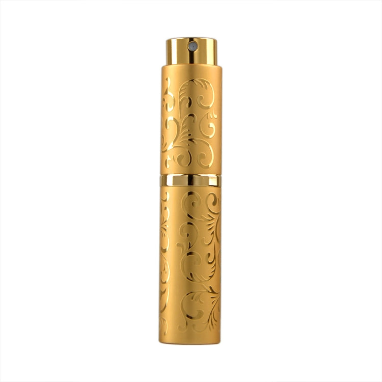 Golden embossed metal perfume spray bottle with twist-top nozzle, 10ml.