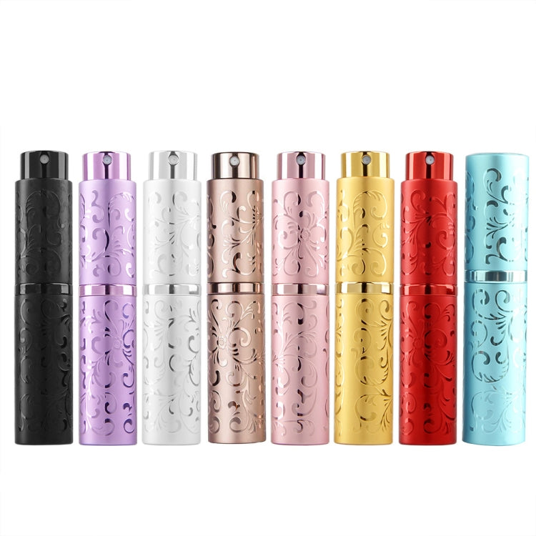 Set of embossed metal perfume spray bottles in multiple colors, twist-top nozzles.