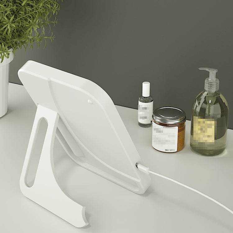 White folding LED makeup mirror on countertop with standing base