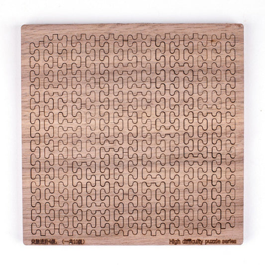 Wooden rectangular jigsaw puzzle board with repeating hook-like maze pattern, light wood