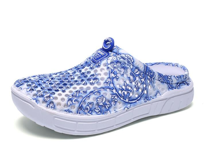 Women's slip-on clogs with blue floral printed fabric and white cushioned sole