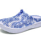 Women's slip-on clogs with blue floral fabric and white cushioned sole, side view