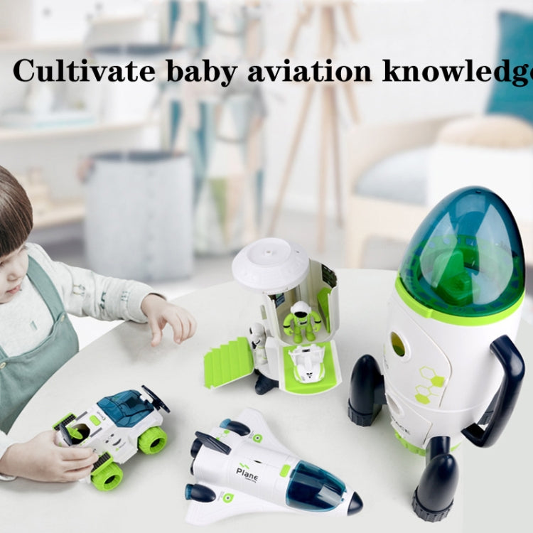 White and green rocket space toy model with blue cockpit window, shown with child