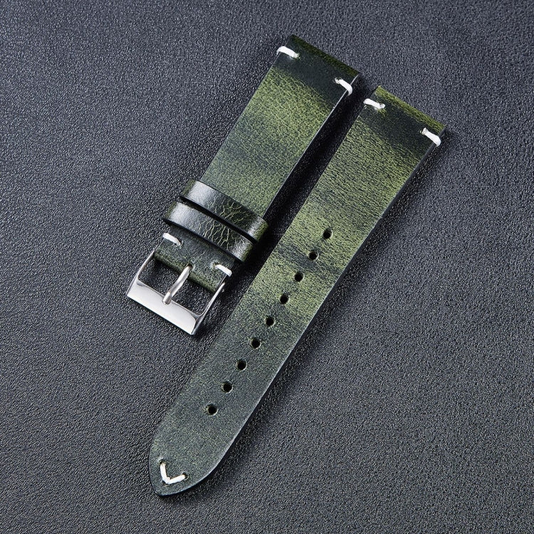Leather watch strap in green with metal buckle, stitched edges, and adjustment holes