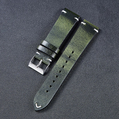 Leather watch strap in green with metal buckle, stitched edges, and adjustment holes