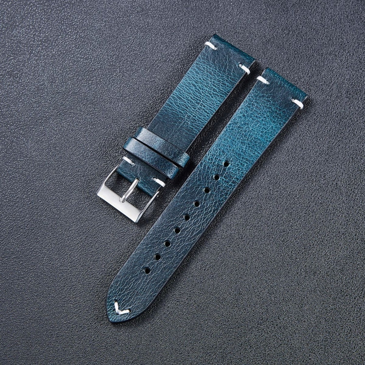 Leather watch strap in blue with metal buckle, stitched finish, and adjustment holes