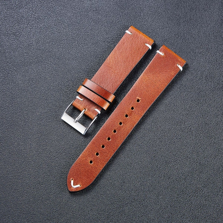 Leather watch strap in tan brown with metal buckle and adjustment holes along the band