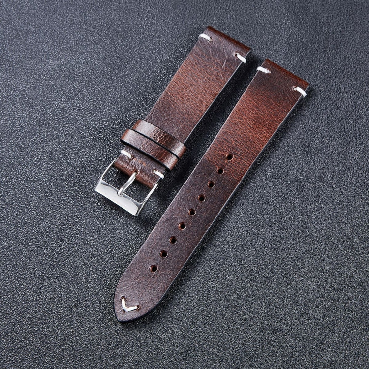 Leather watch strap in dark brown with metal buckle and punched adjustment holes