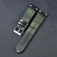 Olive-green leather watch strap with metal buckle and adjustment holes at the side