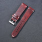 Wine red leather watch strap with metal buckle and punched adjustment holes
