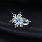 Sterling silver snowflake flower ring with bright blue topaz center and side stones