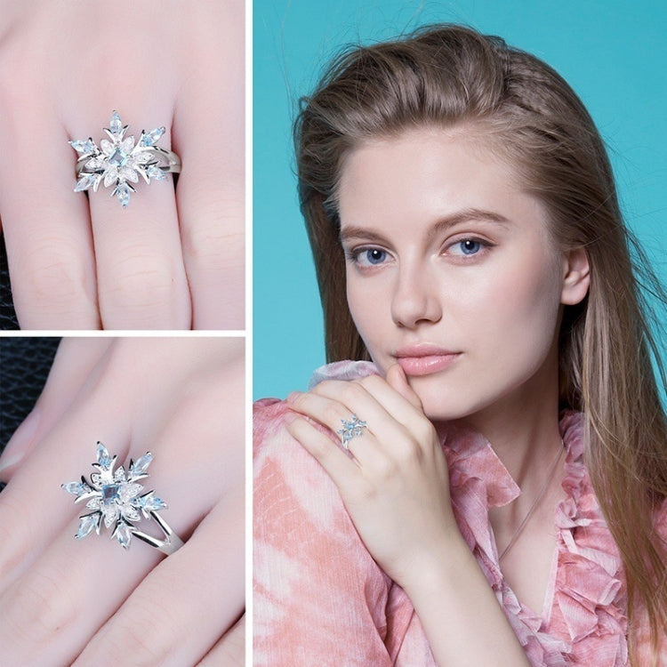 Sterling silver blue topaz snowflake ring on a woman’s finger