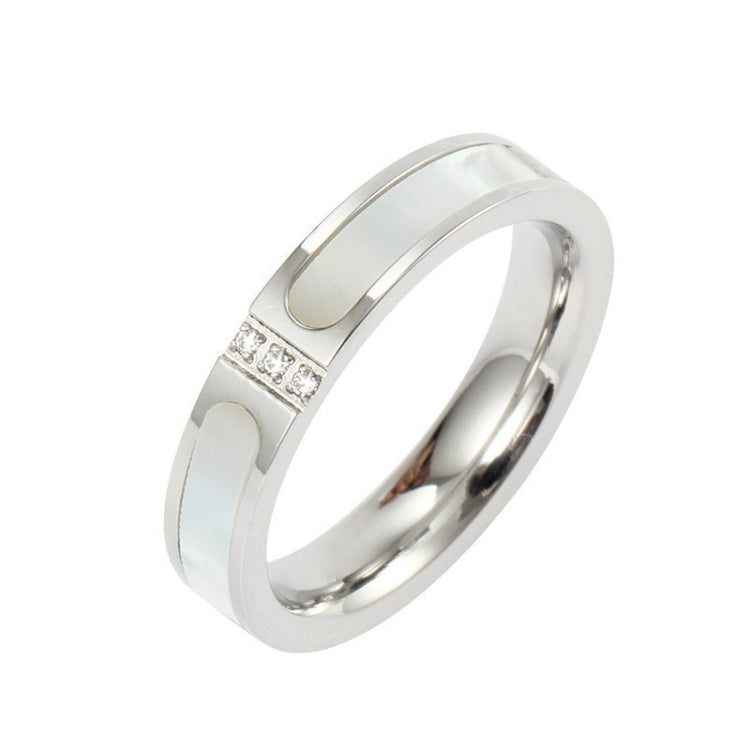 Silver-tone ring with three-diamond inlay at the top of a flat, polished band