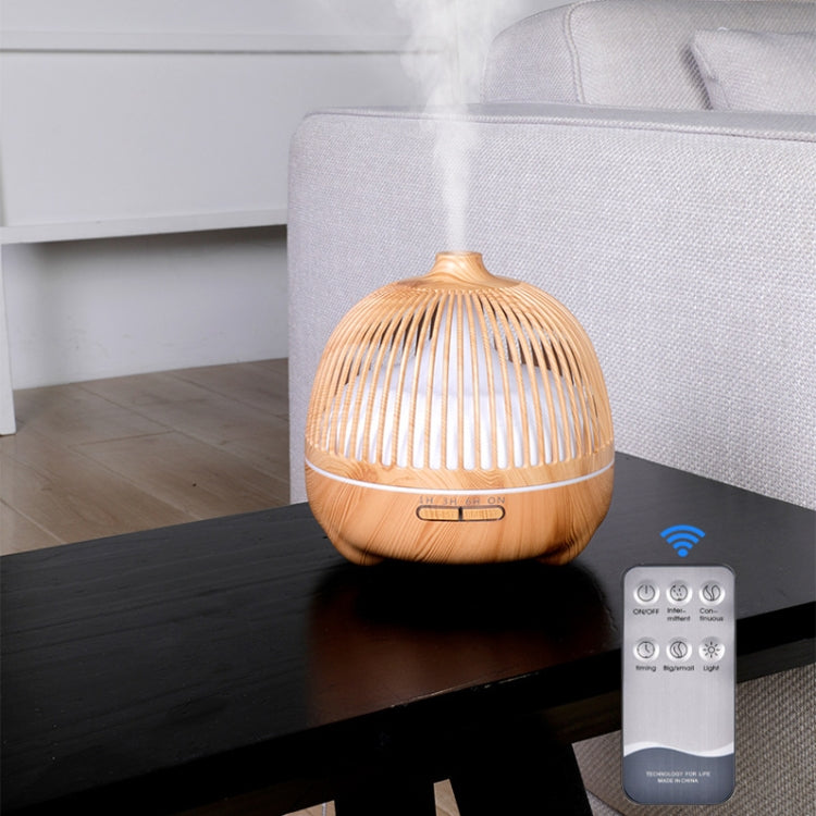 Aroma humidifier night light with birdcage wood shell on tabletop, warm light