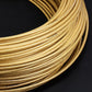 5mm braided cable tube, golden color with braided pattern, coiled bundle