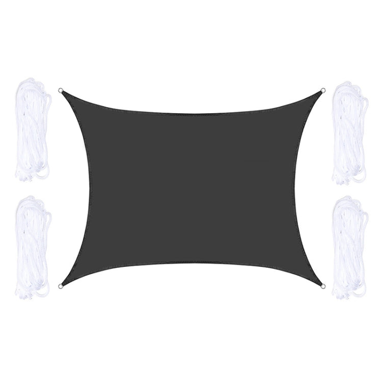 Dark gray outdoor shade sail with corner grommets and white hanging ropes