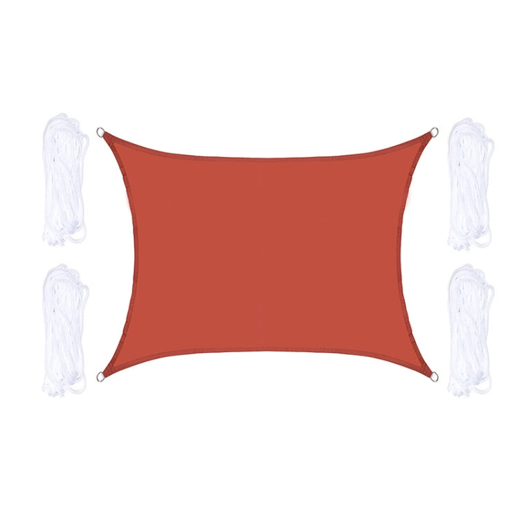 Red outdoor shade sail with corner grommets and white hanging ropes