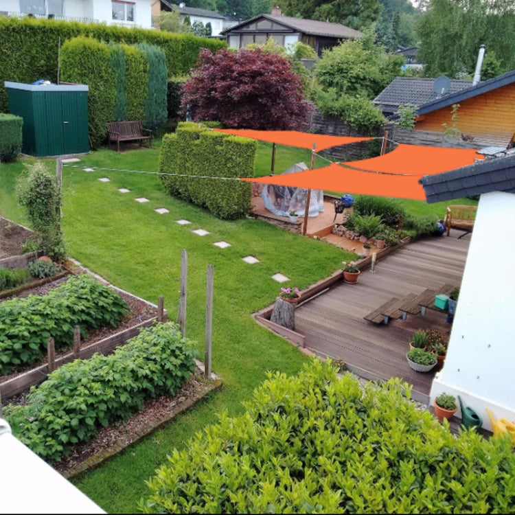 Outdoor waterproof shade sail stretched over garden area in orange canopy